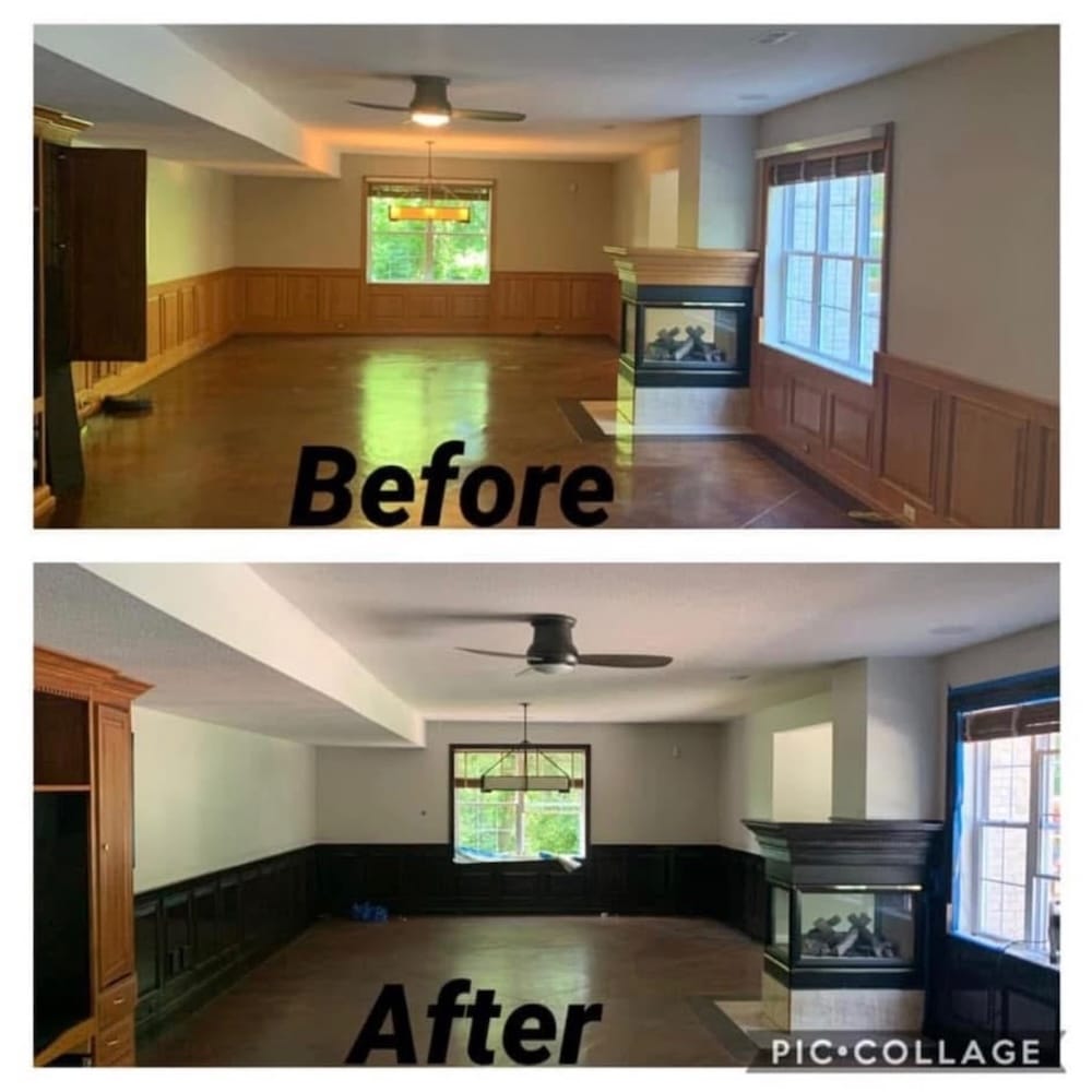 Living room with black paneling on bottom half of walls